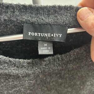 Sweater with buttons on the side, size medium, washed but never worn.